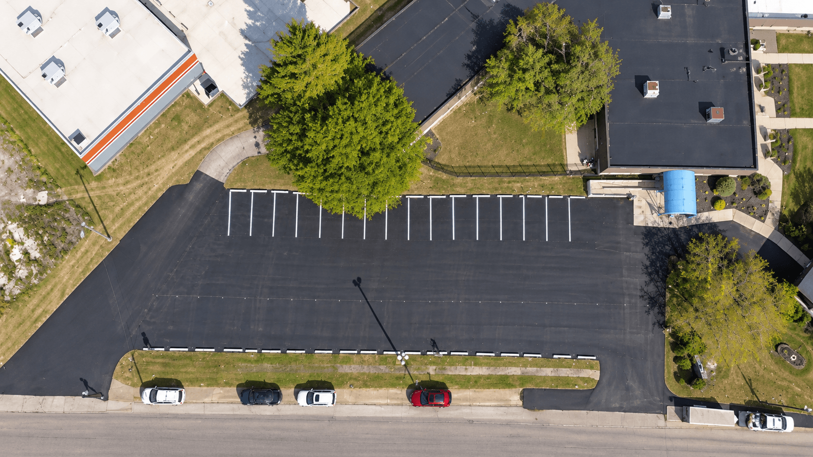 Freshly overlaid parking lot with white ADA-compliant striping at a nursing facility in Ohio