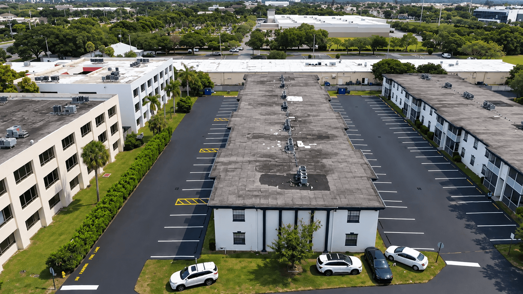 Newly seal coated parking lot surrounding a commercial building complex in Sunrise, FL