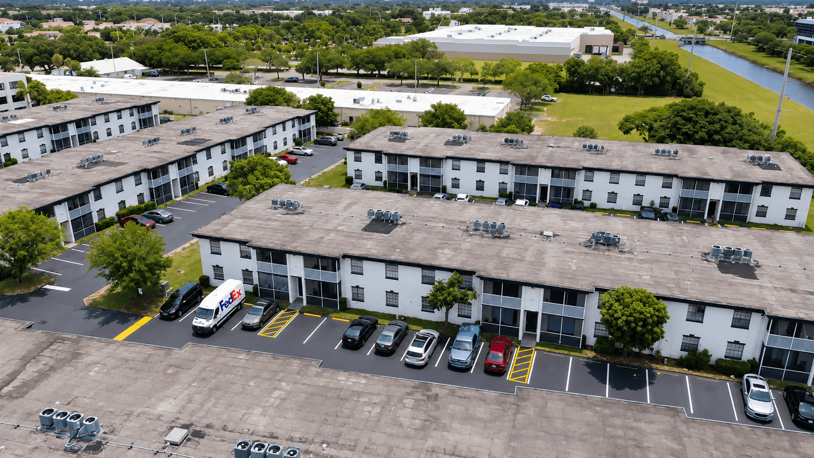 Aerial view of a freshly seal coated commercial parking lot with fire lane markings in Sunrise, FL