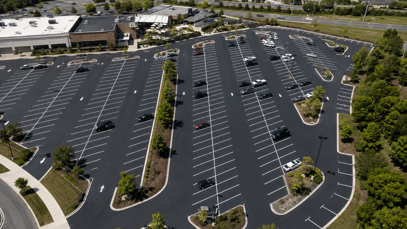 Aerial view of a well-designed commercial parking lot layout with efficient stall angles and clear traffic flow